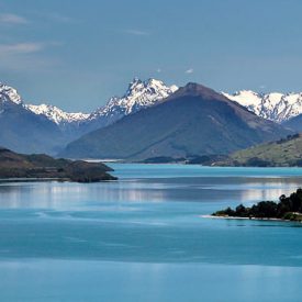 aerial view of lake in taupo and snow capped mountains